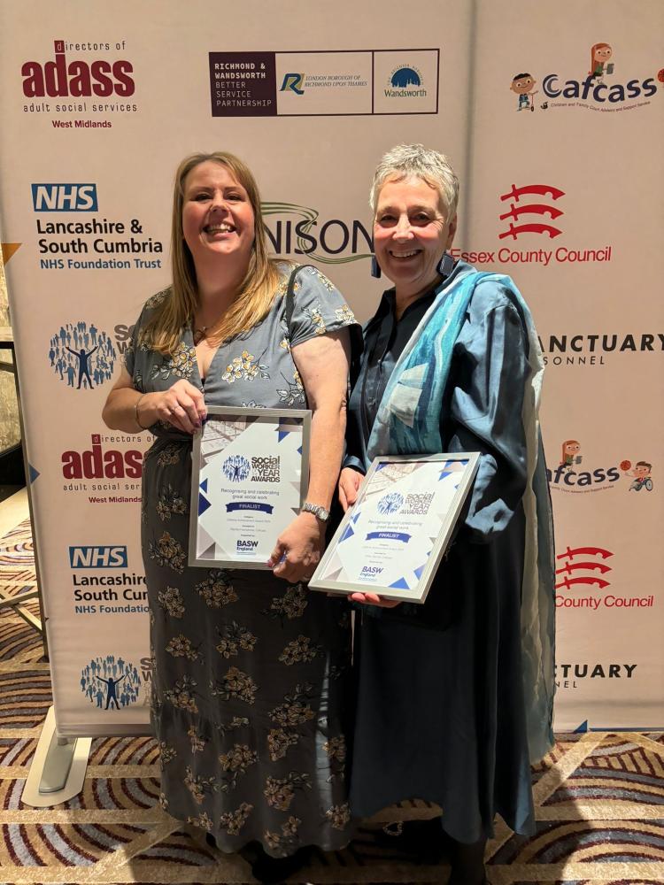 Image of two women holding certificates