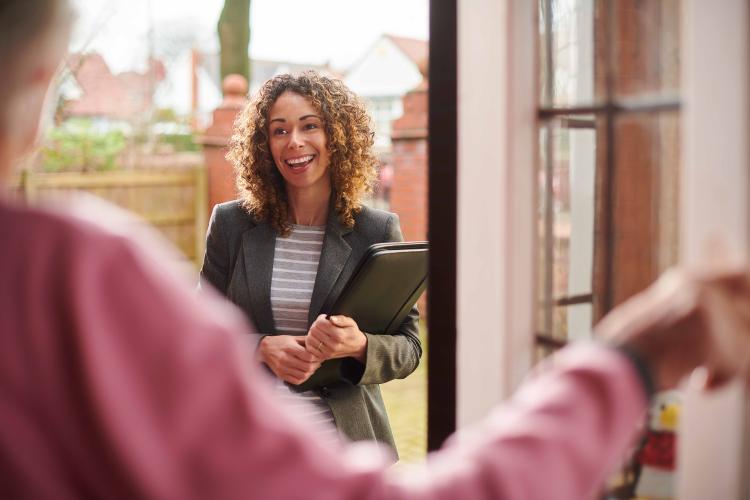 Social worker smiling by door
