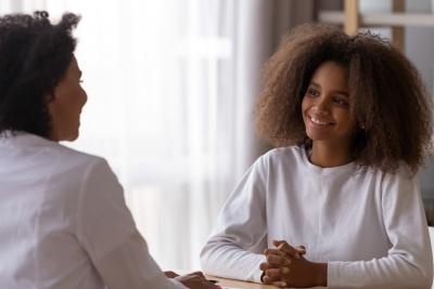 Social work student smiling at woman
